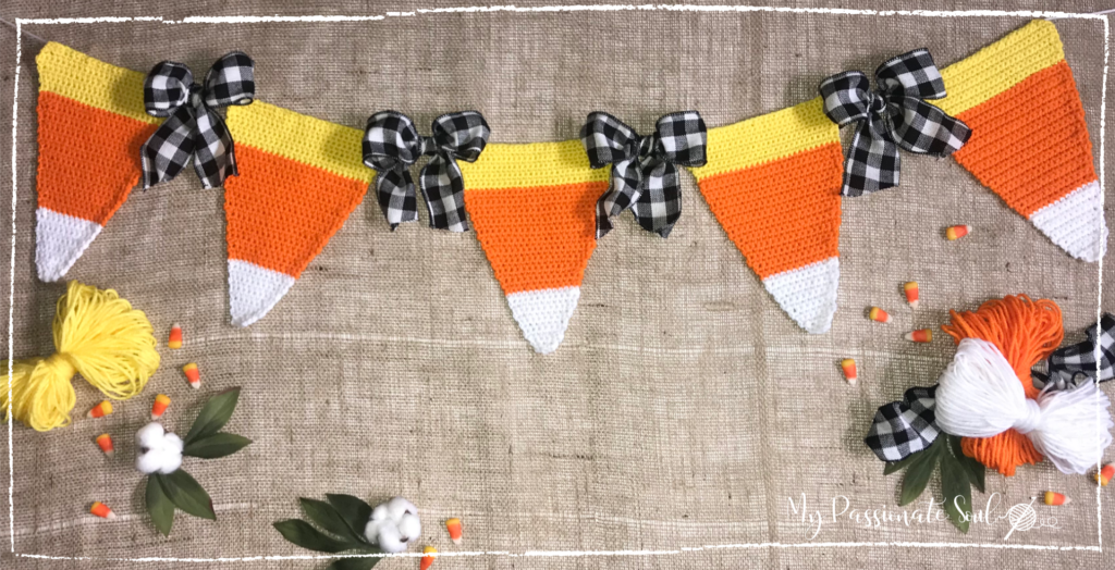 Blog post cover photo showing Crochet Candy Corn Bunting finished and strung on yarn.
